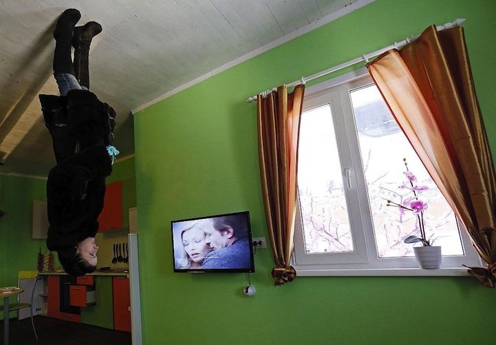 A woman visits a room in a house built upside-down in Russia's Siberian city of Krasnoyarsk